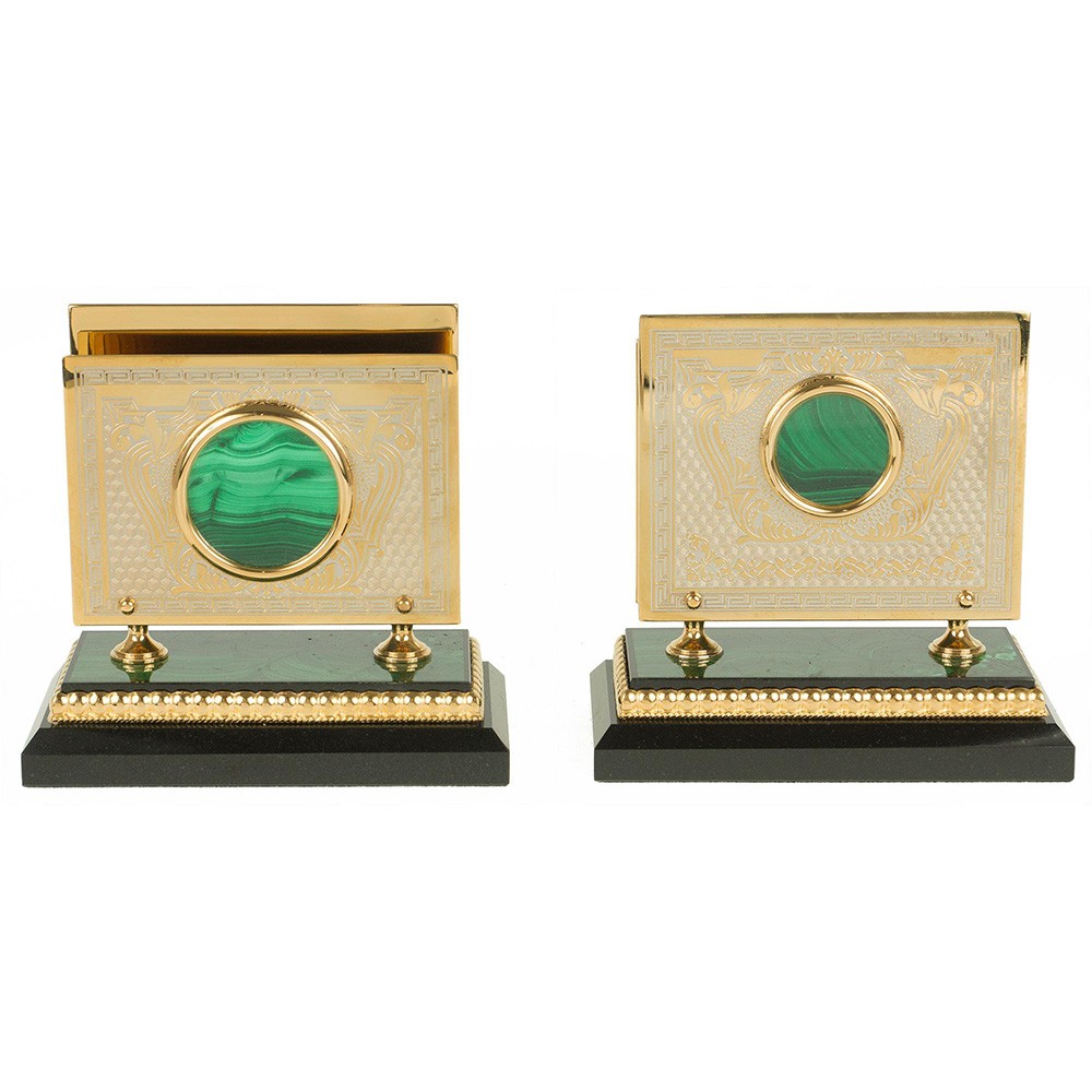 Gold business card holders on a stone base