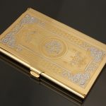 Gold business card holder decorated with hand engraving