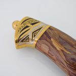 wooden handle with gold trim
