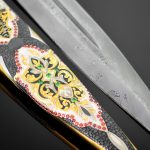 The blade of the dagger is made of Damascus steel, the scabbard is decorated with gold and enamel ornaments.