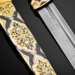The blade of the dagger is made of Damascus steel, the scabbard is decorated with gold and enamel ornaments