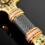 The scabbard is decorated with an ornament of gold and enamel