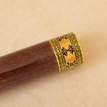 gold plate on wooden handle
