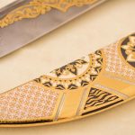 gold scabbard with white and black enamel